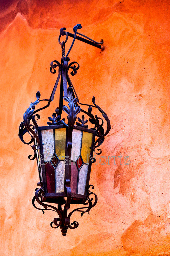 Ornate Lamp, Roussillon 
 Intricate and ornate lamp against a bold orange wall in Roussillon, Provence 
 Keywords: Lamp, intricate, ornate, orange, colour, bold, wall, Roussillon, Provence, France